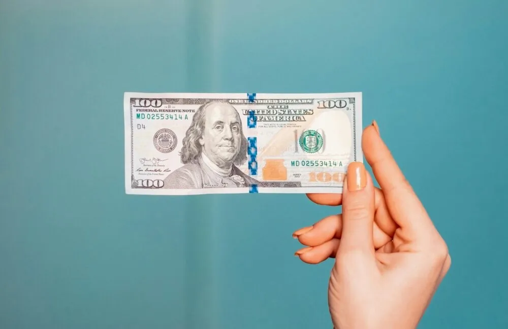 Hand holding liquid cash representing policy loan access