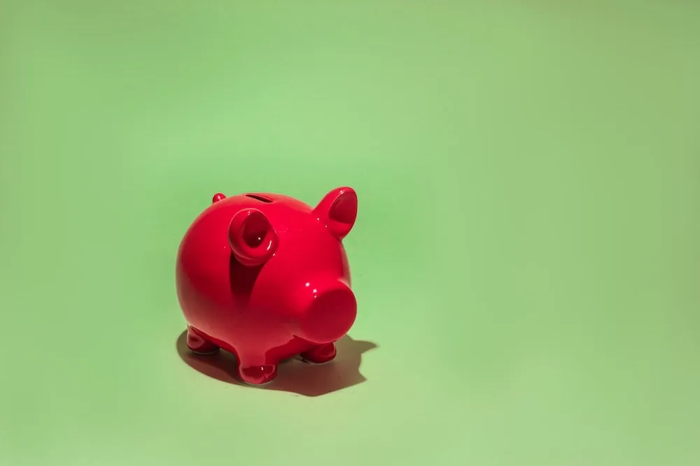 Red piggy bank representing safe savings in Infinite Banking